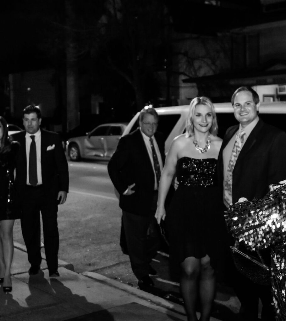 Guests arriving at an evening gala in formal attire